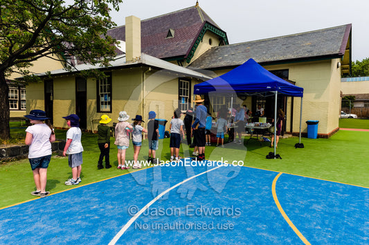 Children line up for a free hotdog at a school fundraising walkathon. Carlton North Primary School, Carlton North, Melbourne, Victoria, Australia.