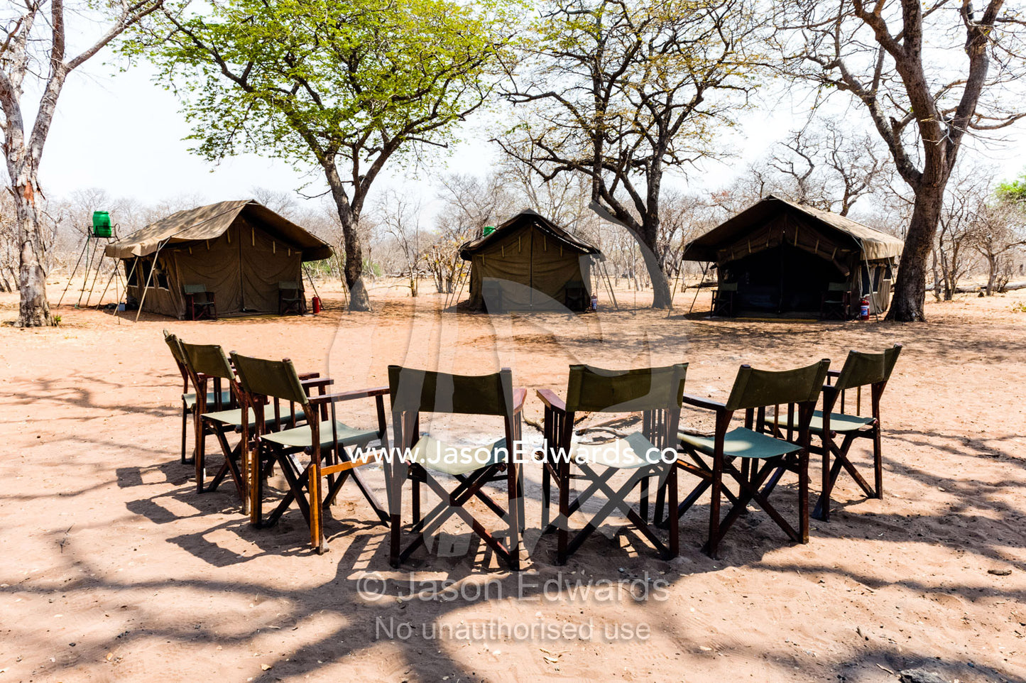 A tented safari camp with canvas chairs in a remote national park. Chobe River, Chobe National Park, Botswana.
