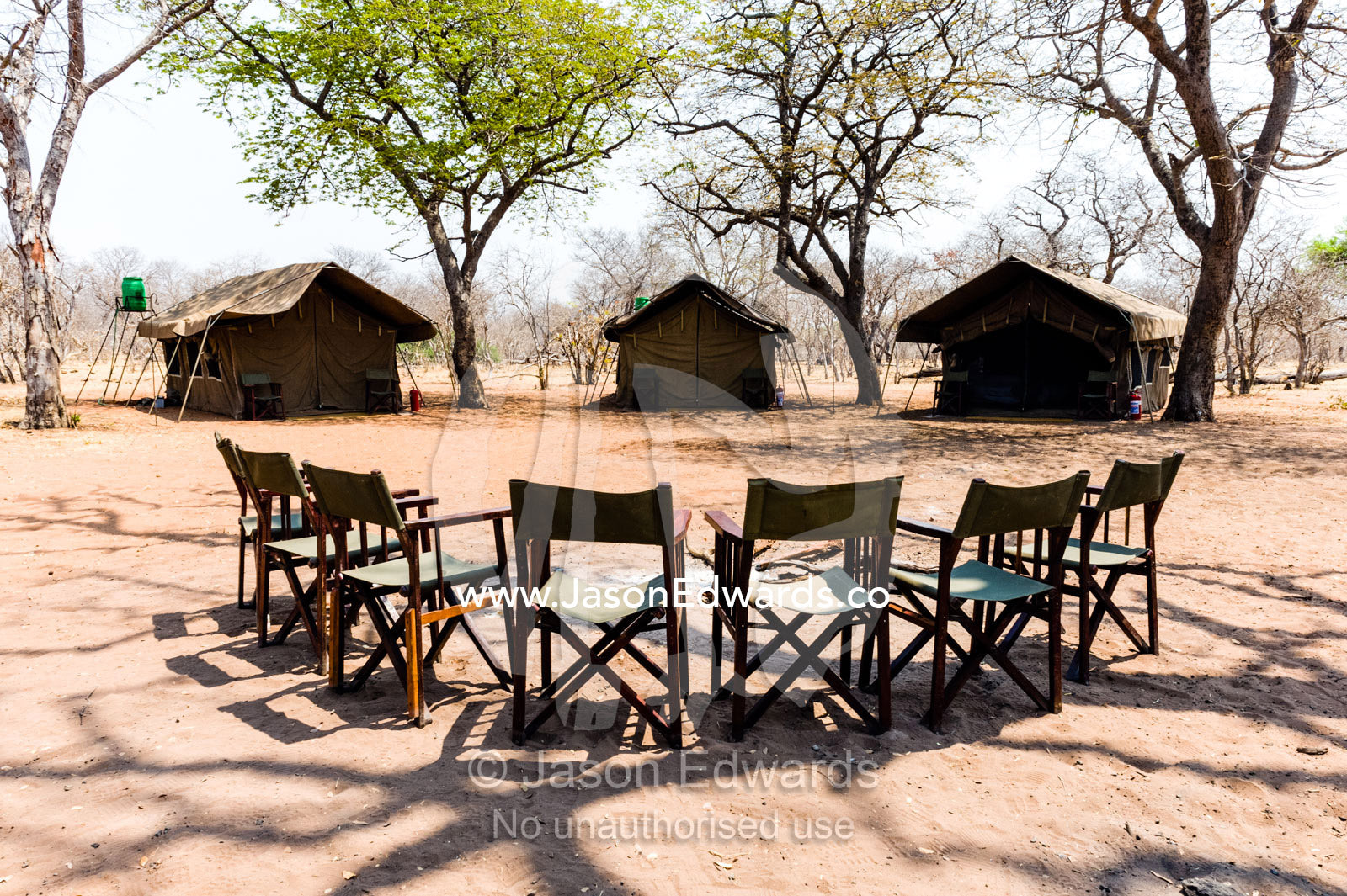 A tented safari camp with canvas chairs in a remote national park. Chobe River, Chobe National Park, Botswana.