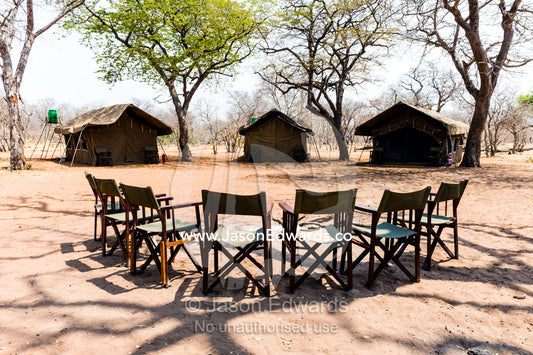 A tented safari camp with canvas chairs in a remote national park. Chobe River, Chobe National Park, Botswana.