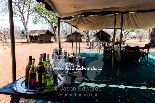 A tented safari camp dining room and alcohol bar in a national park. Chobe River, Chobe National Park, Botswana.