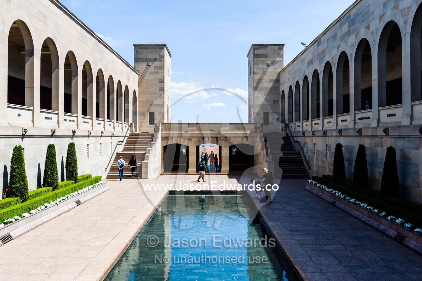 Cloisters containing the Roll of Honour overlook the Memorial Courtyard, Eternal Flame and Memorial Pool leading to the Hall of Memory. Australian War Memorial, Canberra, Australian Capital Territory, Australia.