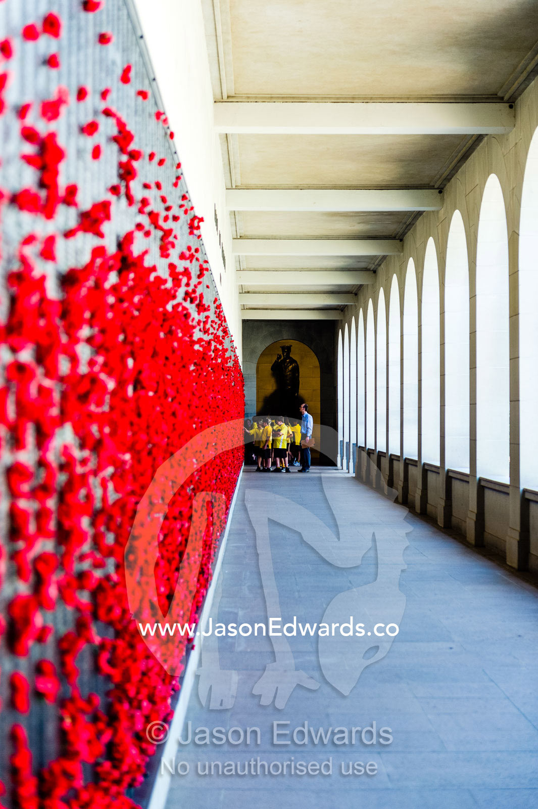 School children visit cloisters containing the Roll of Honour and the names of fallen soldiers remembered with bright red poppies. Australian War Memorial, Canberra, Australian Capital Territory, Australia.