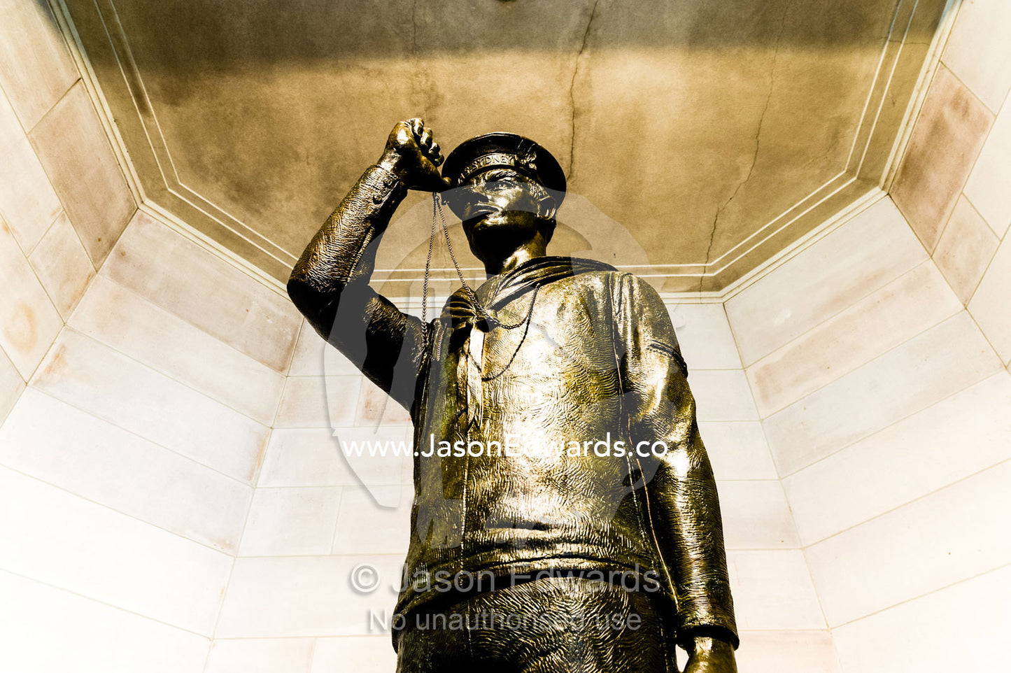 A bronze statue of a sailor from the First World War in uniform about to blow his Bosun's pipe, a type of whistle. Australian War Memorial, Canberra, Australian Capital Territory, Australia.