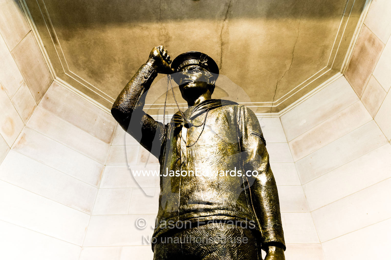 A bronze statue of a sailor from the First World War in uniform about to blow his Bosun's pipe, a type of whistle. Australian War Memorial, Canberra, Australian Capital Territory, Australia.