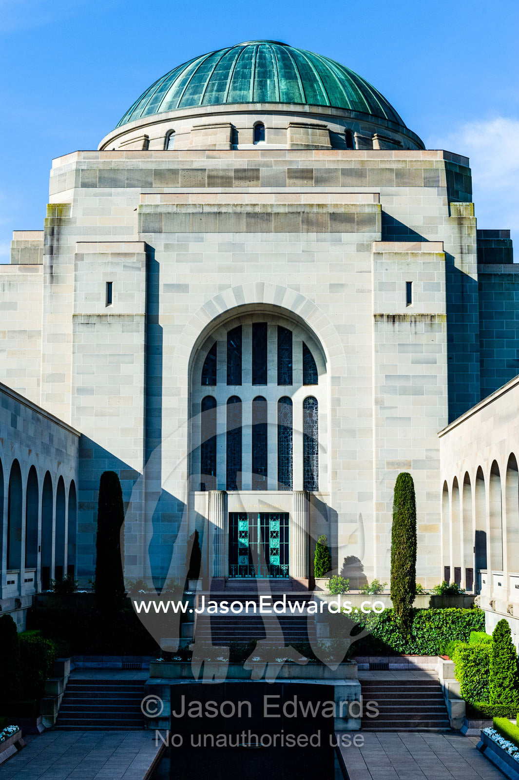 Cloisters containing the Roll of Honour overlook the Memorial Courtyard, Eternal Flame and Memorial Pool leading to the Hall of Memory. Australian War Memorial, Canberra, Australian Capital Territory, Australia.