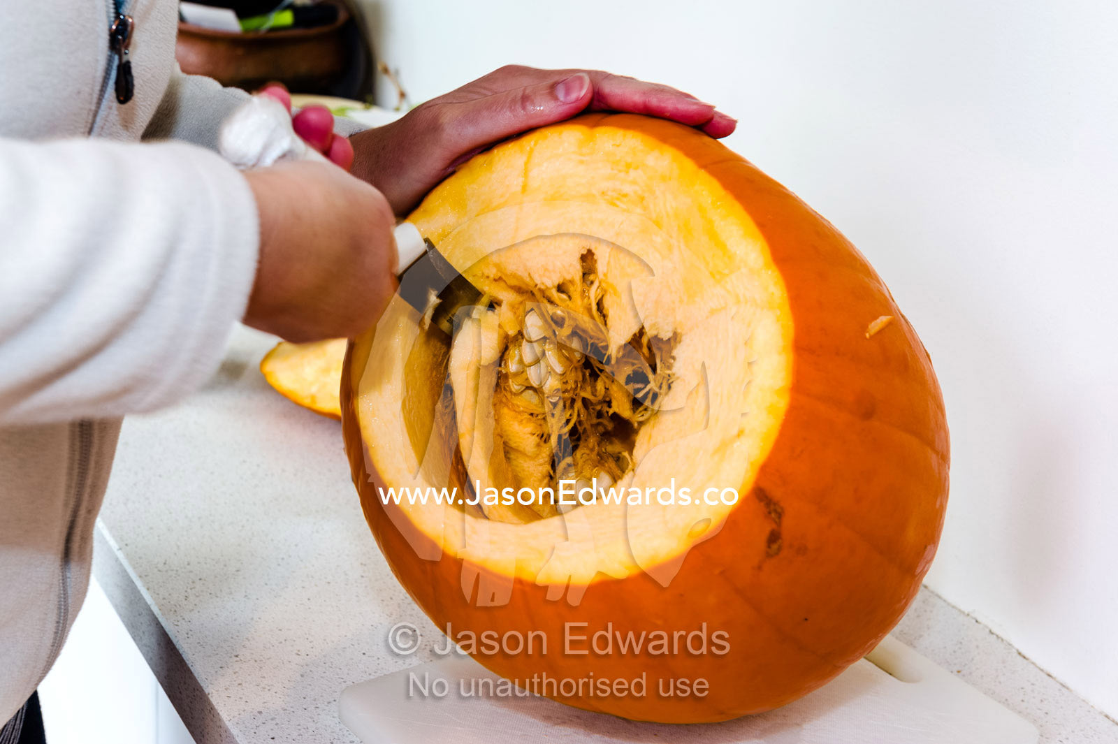 A sharp knife carves out a jack-o'-lantern pumpkin for halloween. Carlton North, Melbourne, Victoria, Australia.