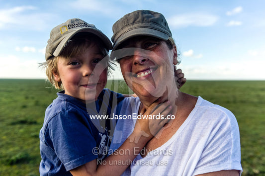 A mother and son enjoying a safari on the African savannah. Ngorongoro Conservation Area, Ngorongoro District, Tanzania.