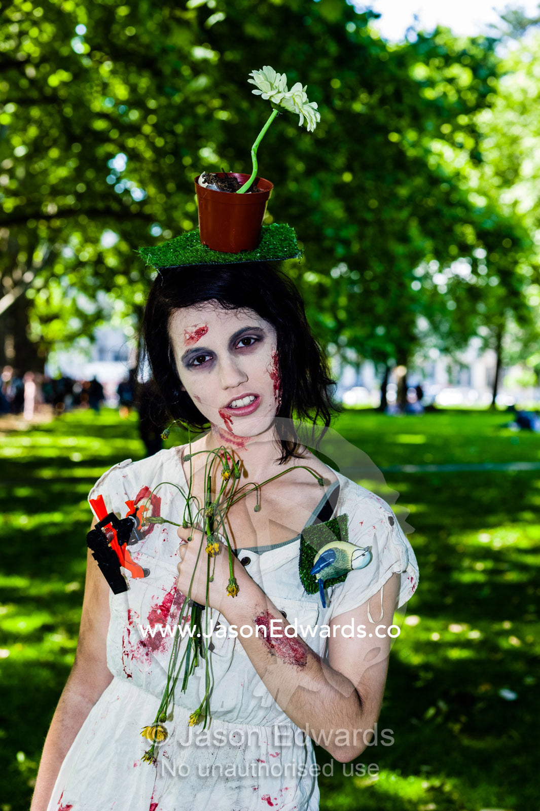 An artistic lady dressed as a zombie with a flowerpot on her head at a festival. Carlton Gardens, World Heritage Site, Carlton, Melbourne, Victoria, Australia.