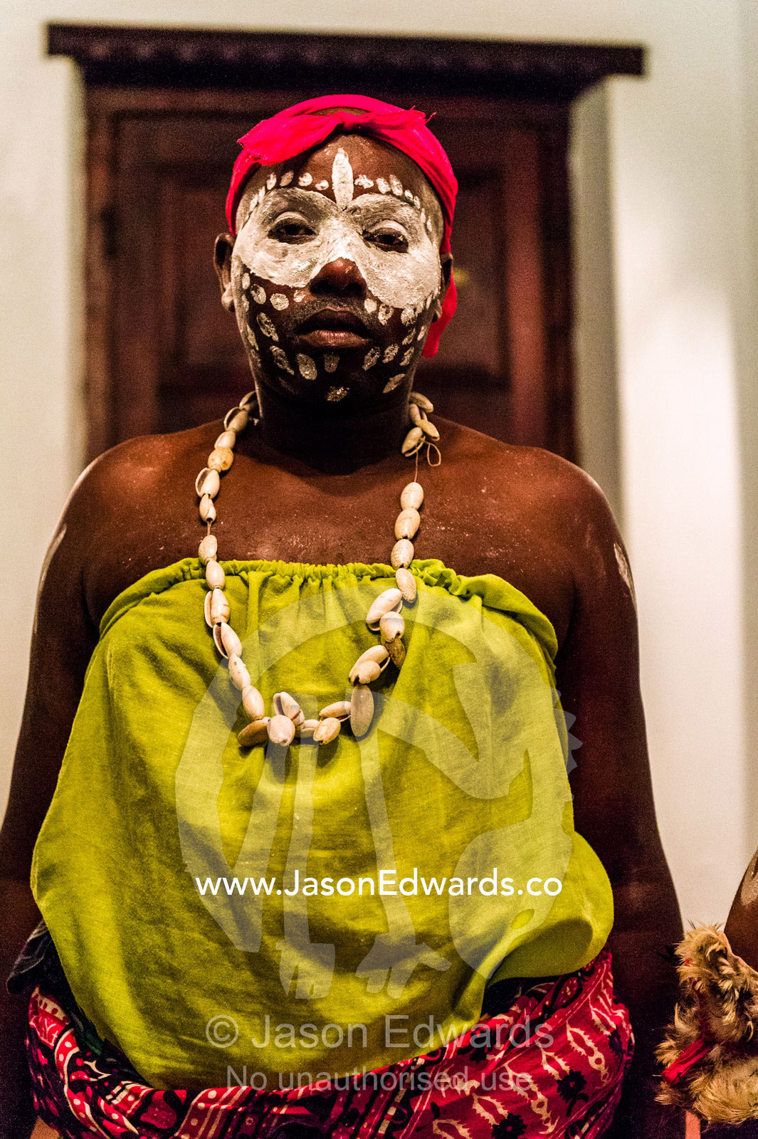 A Spirit dancer decorated in facial paint, shell necklace and a pink bandana. Stone Town, Mji Mkongwe, Zanzibar, Unguja Island, Zanzibar, Tanzania.