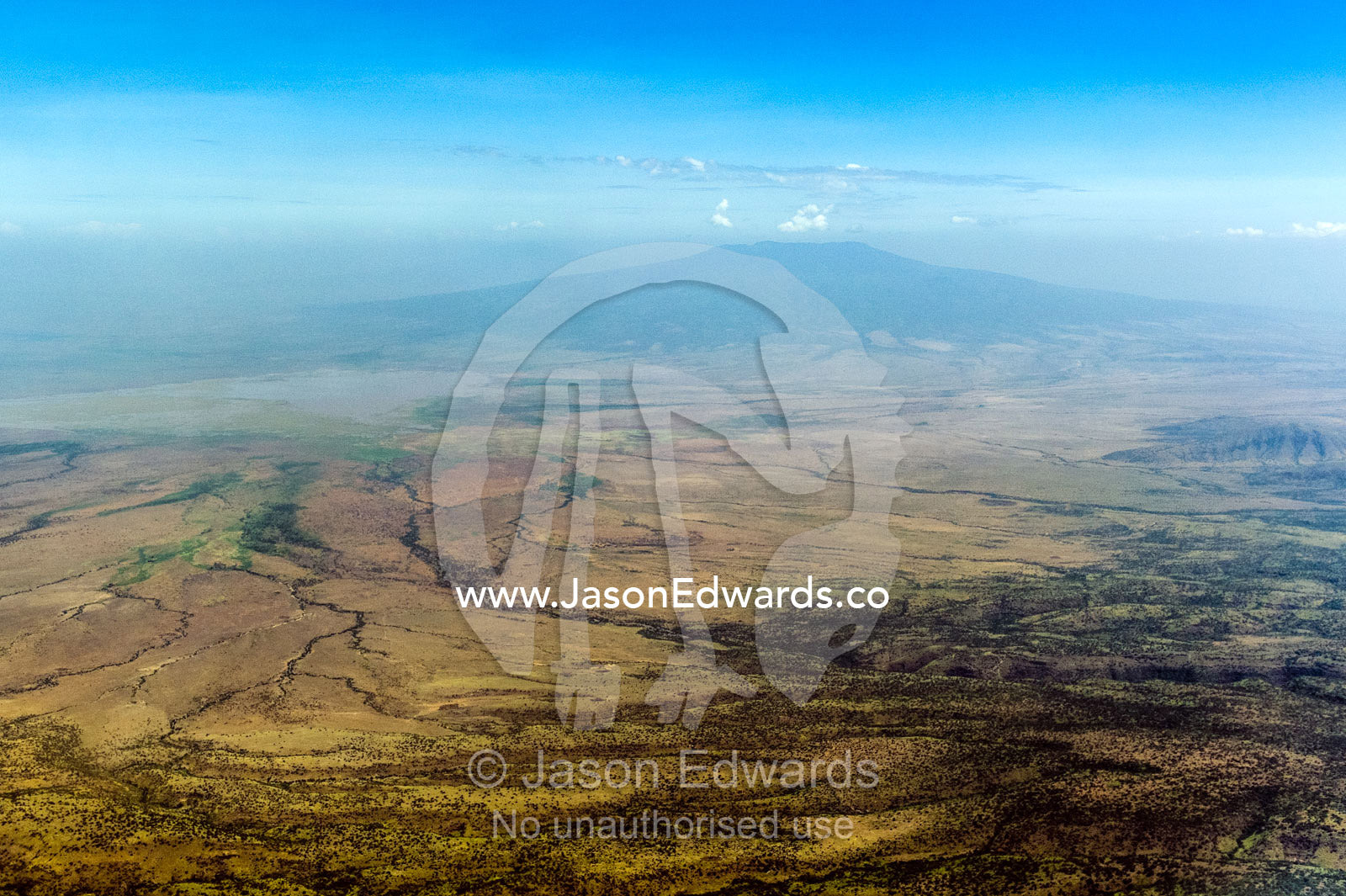 Dry riverbeds and parched plain beneath the slopes of a volcano caldera. Arusha Region, Arusha District, Tanzania.