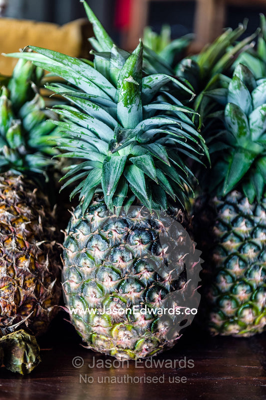 Fresh spiky pineapples resting on a shelf in a breakfast dining room. Karatu, Rhotia Valley Lodge, Rhotia Valley, Karatu District, Arusha Region, Tanzania.