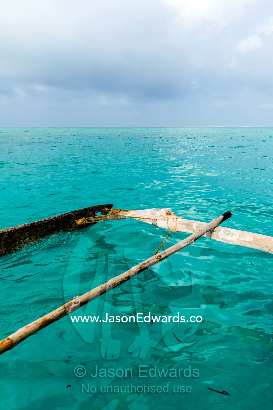 The lashed outrigger used to balance a wooden sailing dhow fishing boat. Bwejuu, Unguja Island, Zanzibar, Tanzania.
