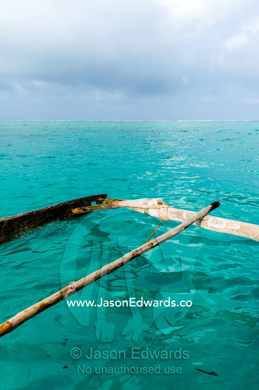 The lashed outrigger used to balance a wooden sailing dhow fishing boat. Bwejuu, Unguja Island, Zanzibar, Tanzania.