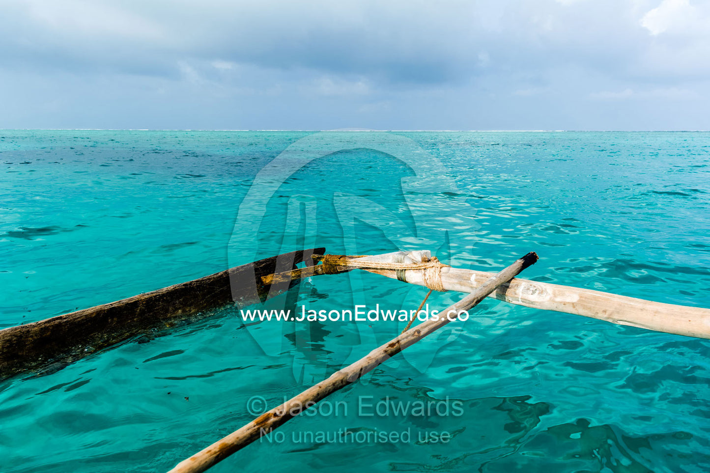 The lashed outrigger used to balance a wooden sailing dhow fishing boat. Bwejuu, Unguja Island, Zanzibar, Tanzania.