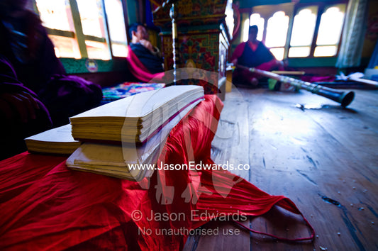 Piles of parchment covered in Sanskrit text played by Buddhist monks on dungchen horns at a death ceremony in a Bhutanese home. Ganteng, Wangdue Phodrang District, Phobjika Valley, Phobjikha Valley, Gangteng Valley, Black Mountains, Bhutan.