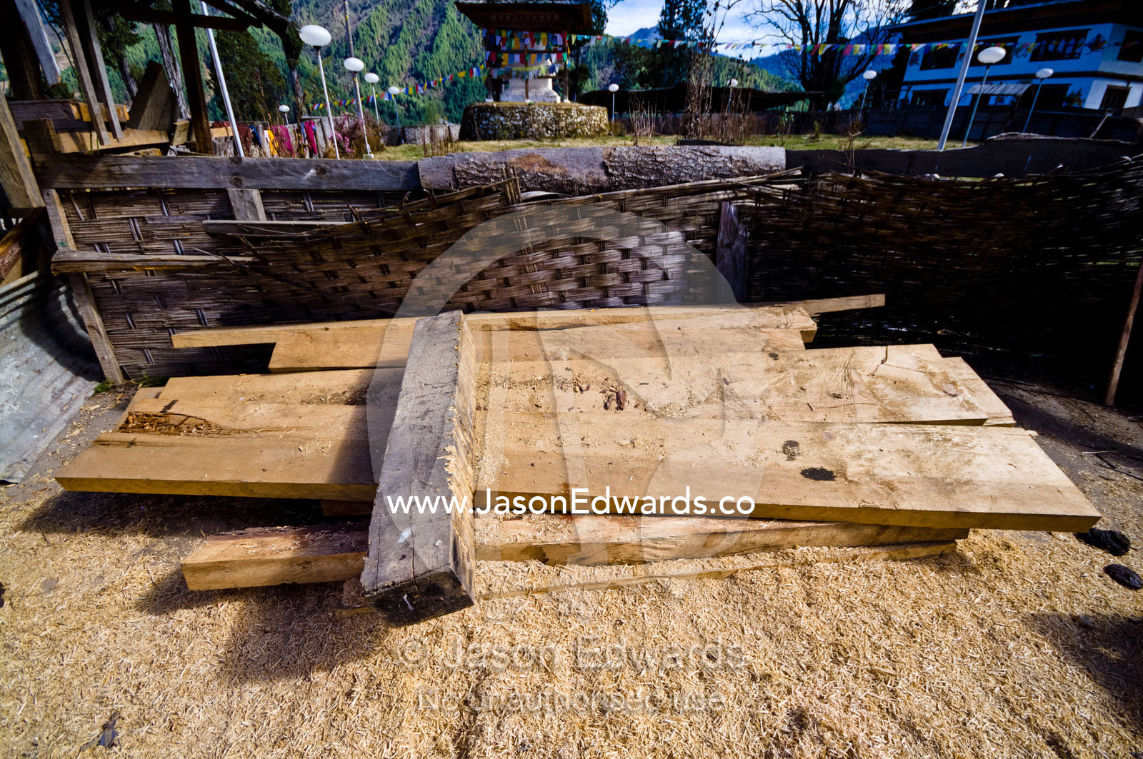 Freshly sawn timber beams surrounded by sawdust to be used to renovate a Buddhist monastery. Gangteng Monastery, Ganteng, Wangdue Phodrang District, Phobjika Valley, Phobjikha Valley, Gangteng Valley, Black Mountains, Bhutan.