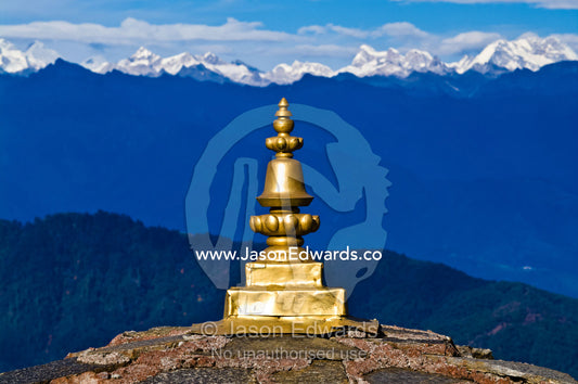 The golden cupola spire on a chorten faces the snowy Himalaya peaks. 108 Druk Wangyal Khangzang Chortens, Dochula Pass, Thimphu District, Bhutan.