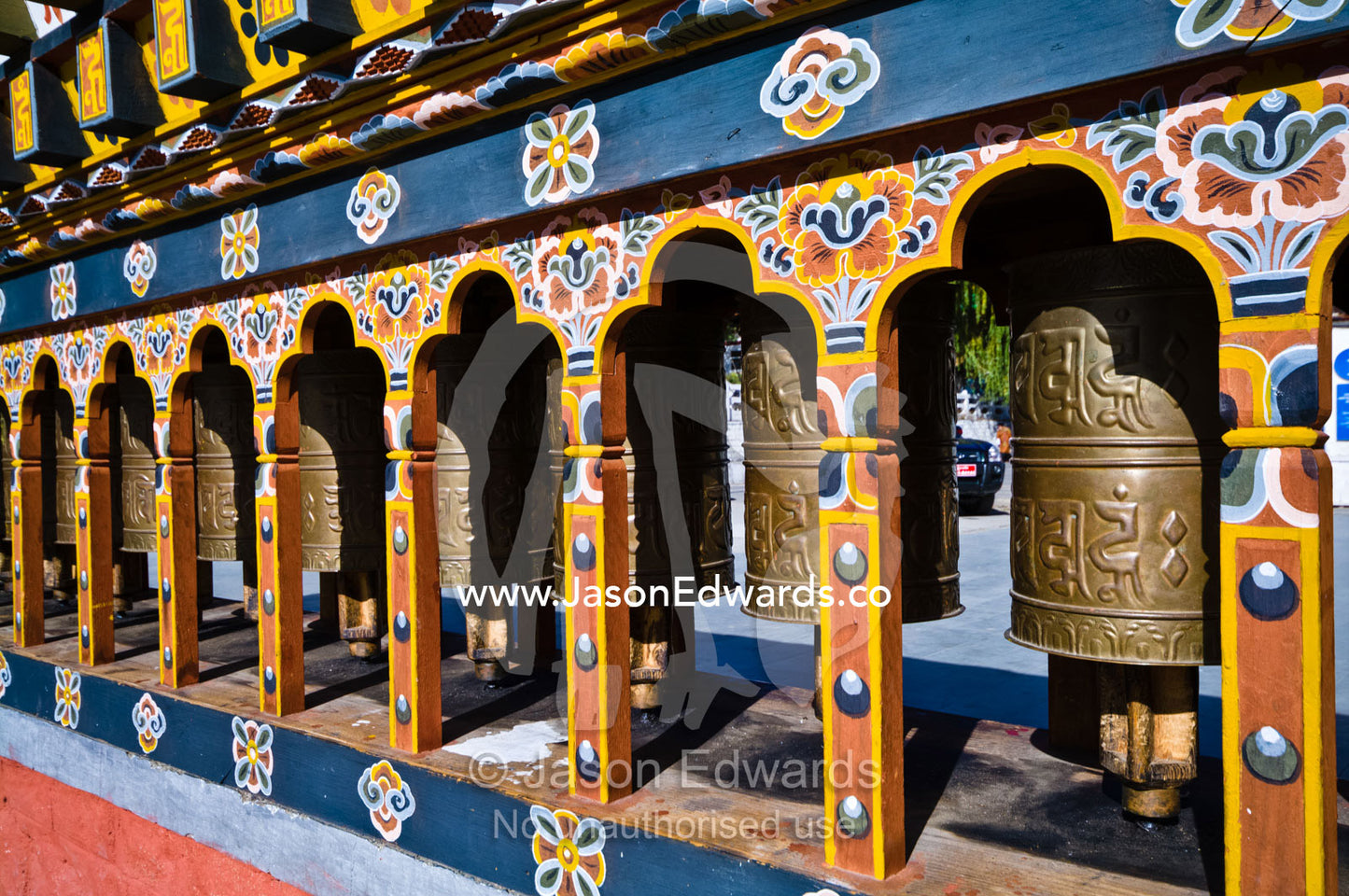 Religious symbols on a spinning brass prayer wheels in a Himalayan town square. Thimphu, Thimphu District, Bhutan.