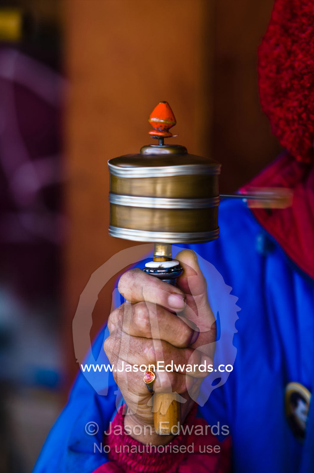 A Buddhist spinning a prayer wheel for prayers and aspirations at a Memorial Chorten. Thimphu Memorial Chorten, Thimphu Bhutan.