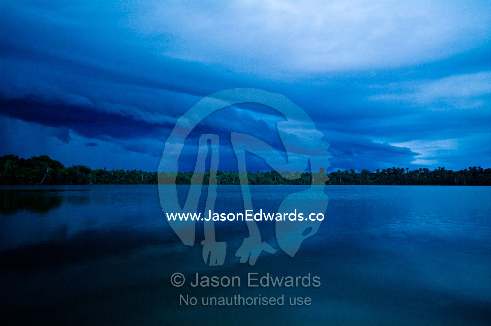 A shelf cloud rolls across the Amazon basin rainforest bringing rain and the night. Quistococha Lake, Lago de Quistococha, Parque de Quistococha, Quistococha Zoo, Iquitos, Amazon Basin, Loreto Region, Maynas Province, Peru.