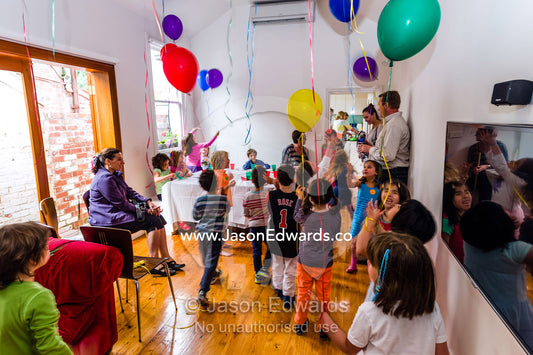 Children playing with balloons at a birthday party. Carlton North, Melbourne, Victoria, Australia.