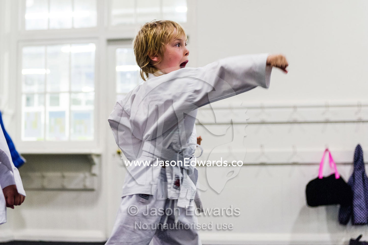 A boy practices a punching move during a karate training session. Carlton North, Melbourne, Victoria, Australia.