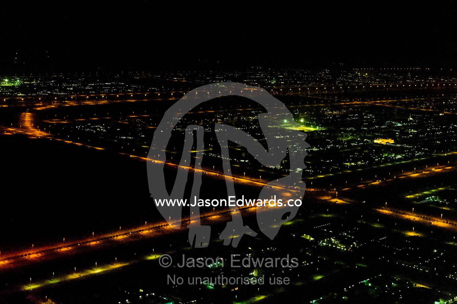 An aerial view of street lighting along roads leading between oil refineries at night. Dubai, United Arab Emirates, UAE, Persian Gulf, Dubai.