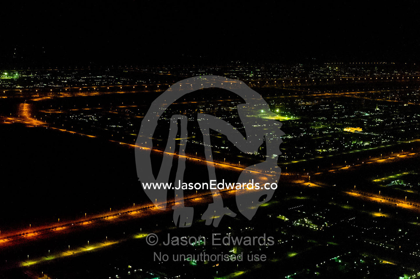 An aerial view of street lighting along roads leading between oil refineries at night. Dubai, United Arab Emirates, UAE, Persian Gulf, Dubai.