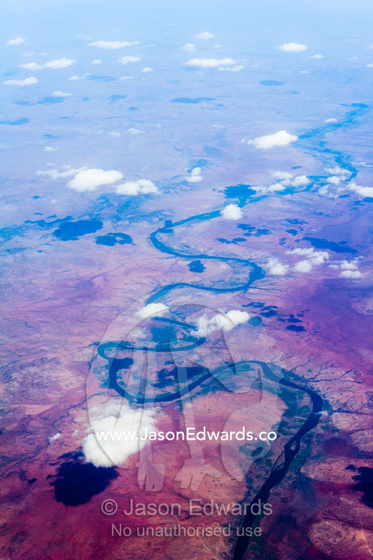 An aerial view of a river winding it's way across a desert plain. Over South-eastern Ethiopia.