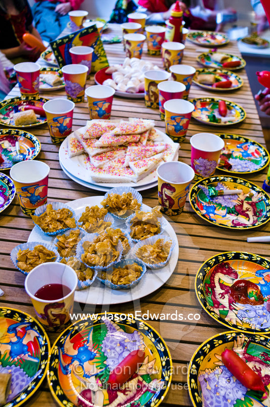 Party food and drinks fill a table at a children's birthday party. Carlton North, Melbourne, Victoria, Australia.