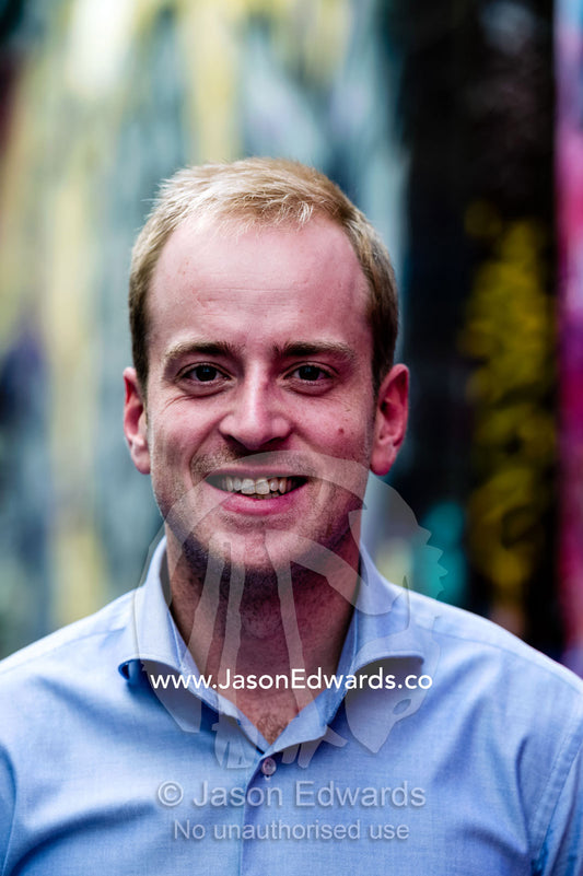 A young, confident and progressive businessman smiling in a collared shirt. St Kilda Road, Melbourne, Victoria, Australia.