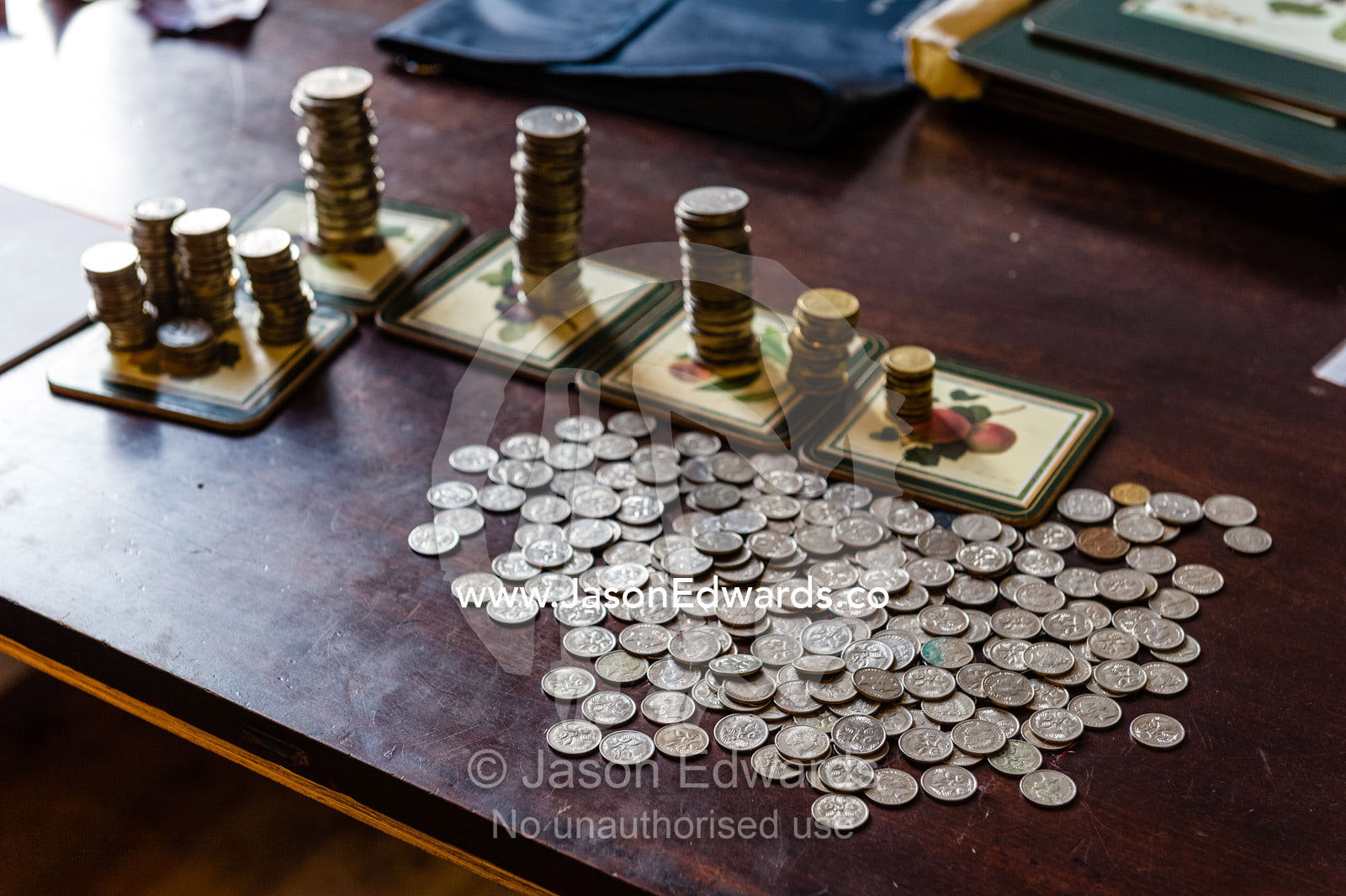 Coins from a child's money-box being sorted into their currency denominations for counting at the bank. Carlton North, Melbourne, Victoria, Australia.