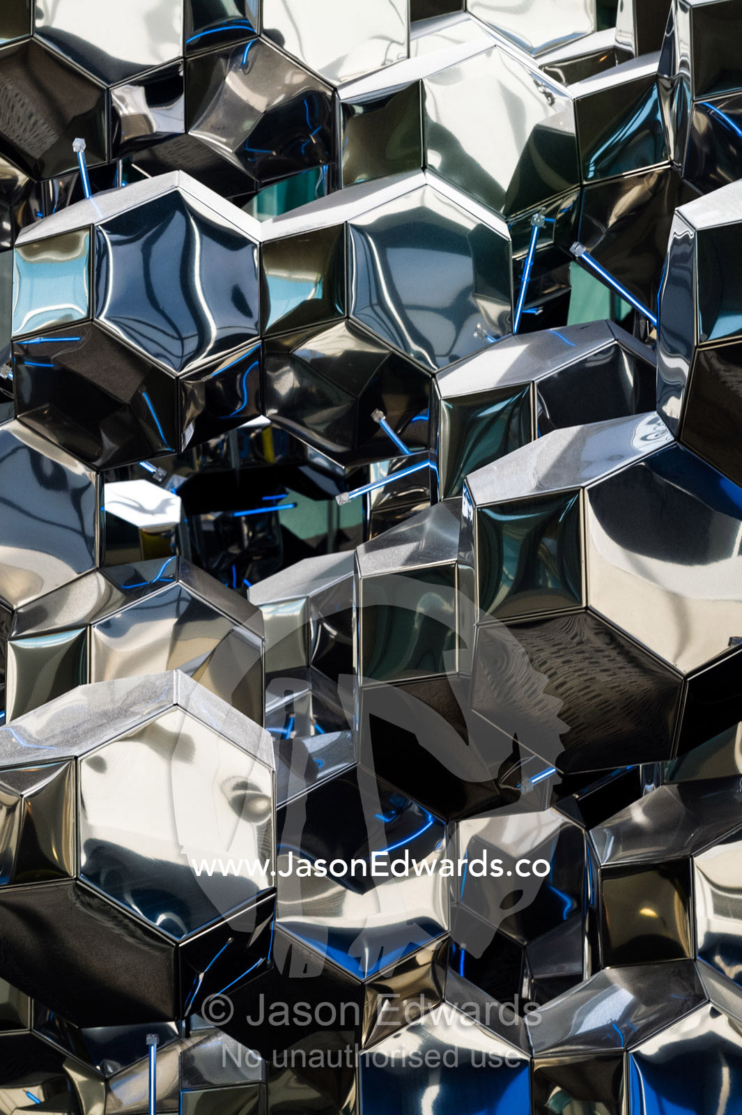 A stainless steel sculpture  reflecting lights in an airport terminal. Kuala Lumpur International Airport, Sepang District, Selangor, Malaysia.