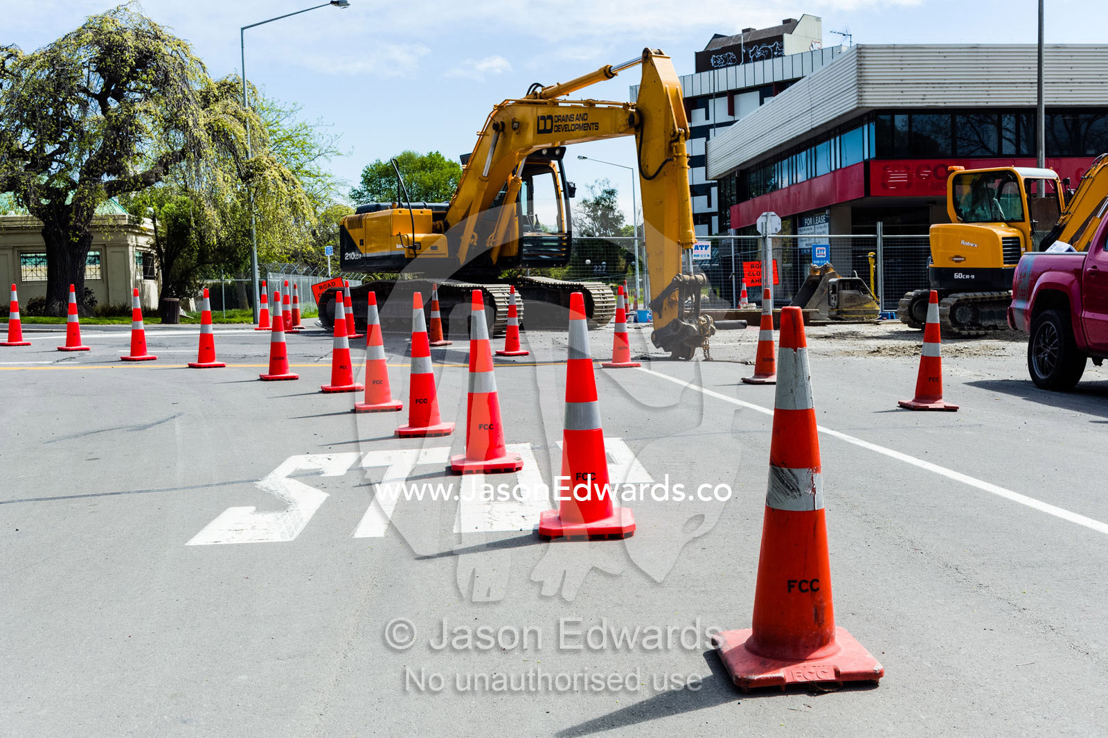 Witches cones direct traffic from construction vehicles repairing damage to a road after an earthquake. Christchurch, South Island, New Zealand.