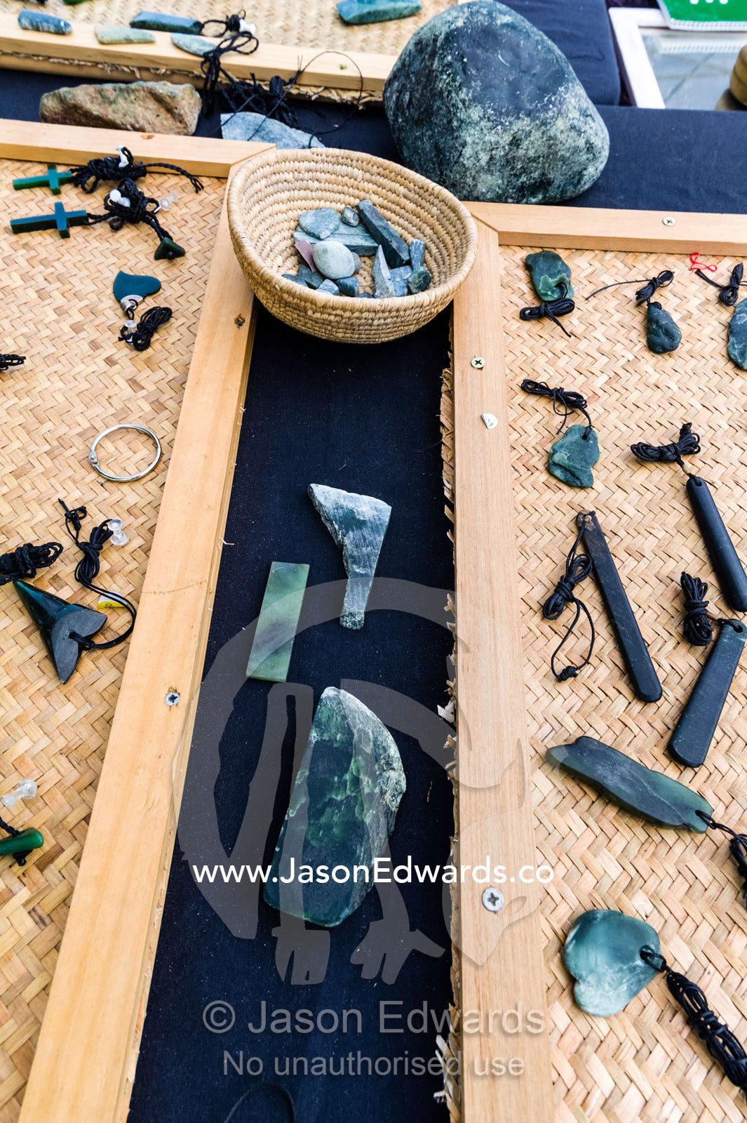 A street stall selling Pounamu stone pendants in a city square. Christchurch, South Island, New Zealand.