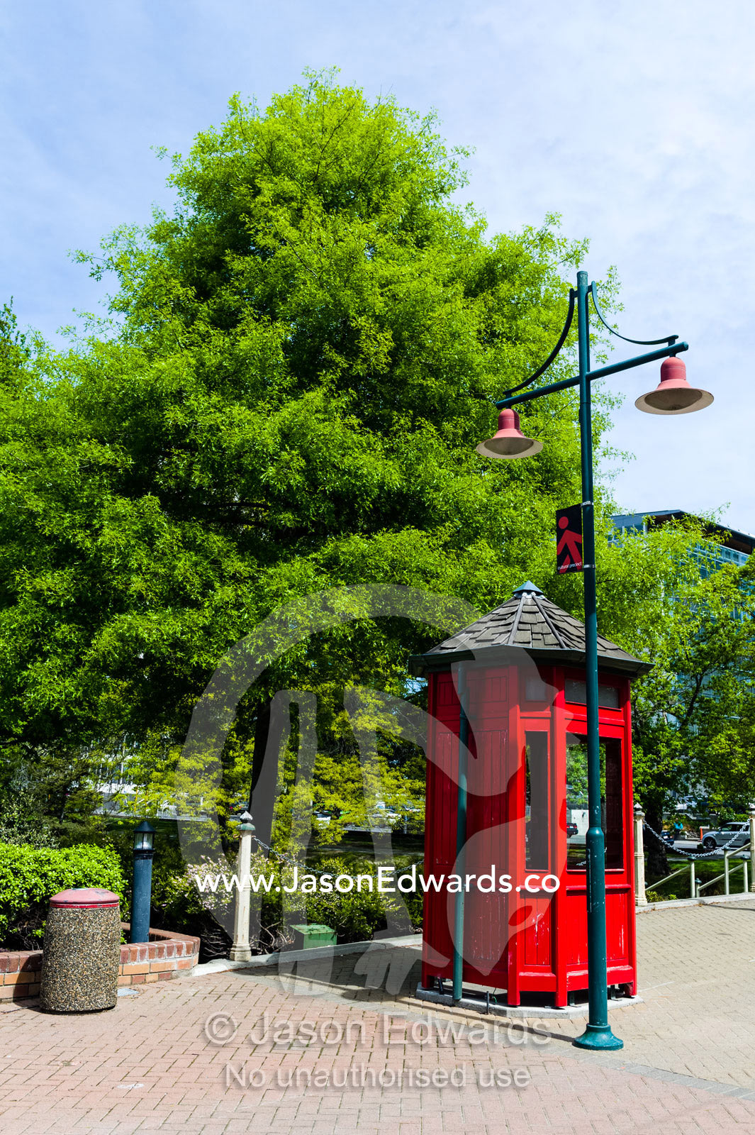 An antique bright red English telephone box and streetlight Christchurch, South Island, New Zealand