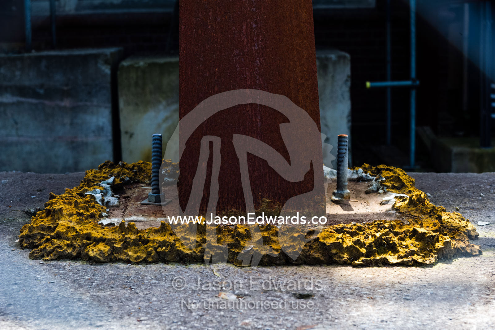 A steel girder is bolted and glued to a sidewalk to support a building damaged in an earthquake. Christchurch, South Island, New Zealand.