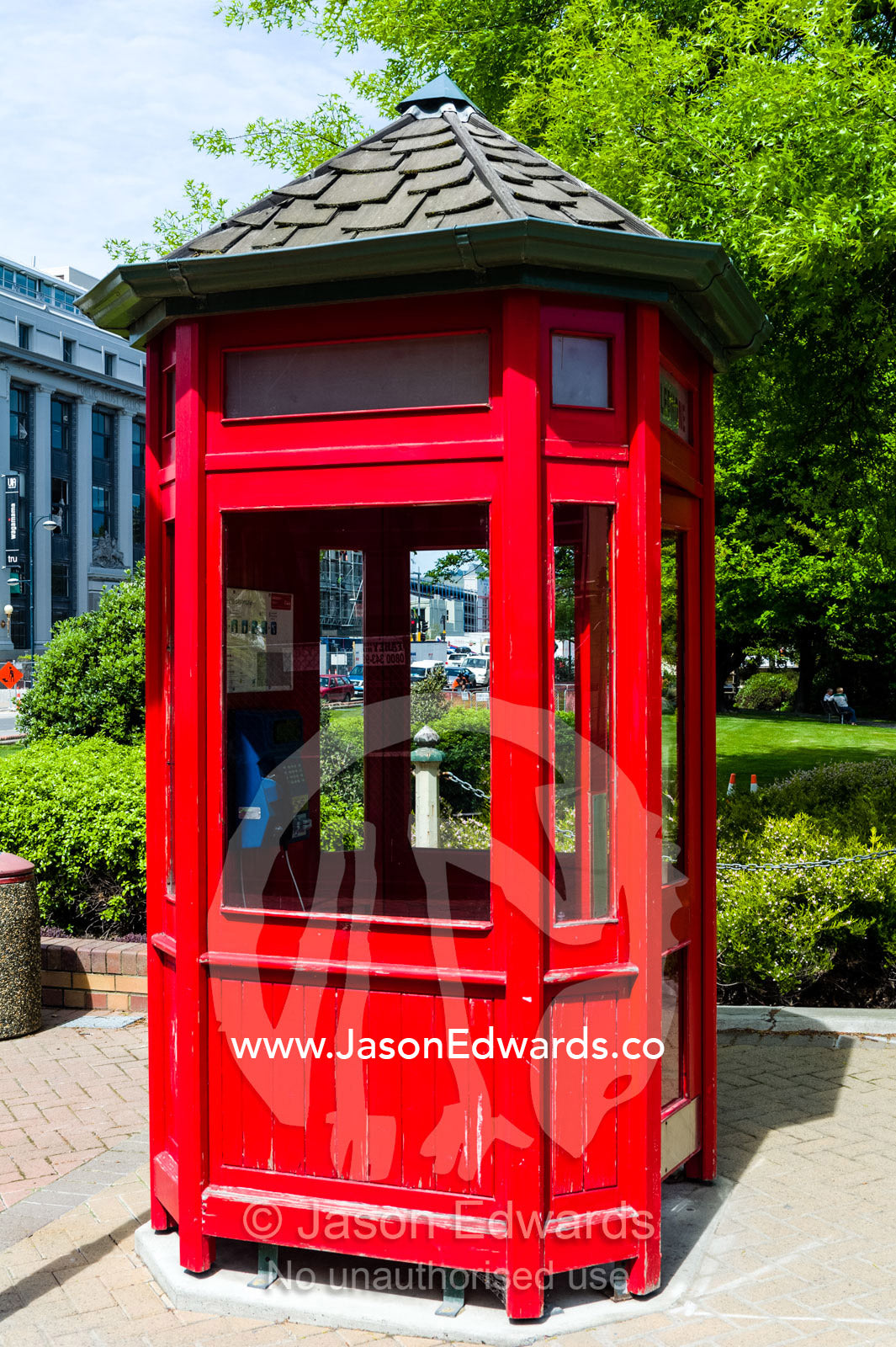 An antique bright red English telephone box. Christchurch, South Island, New Zealand.