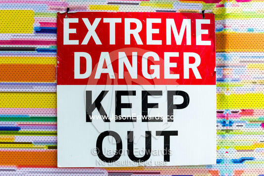 A sign warns of danger in a building that was damaged during an earthquake. Christchurch, South Island, New Zealand.