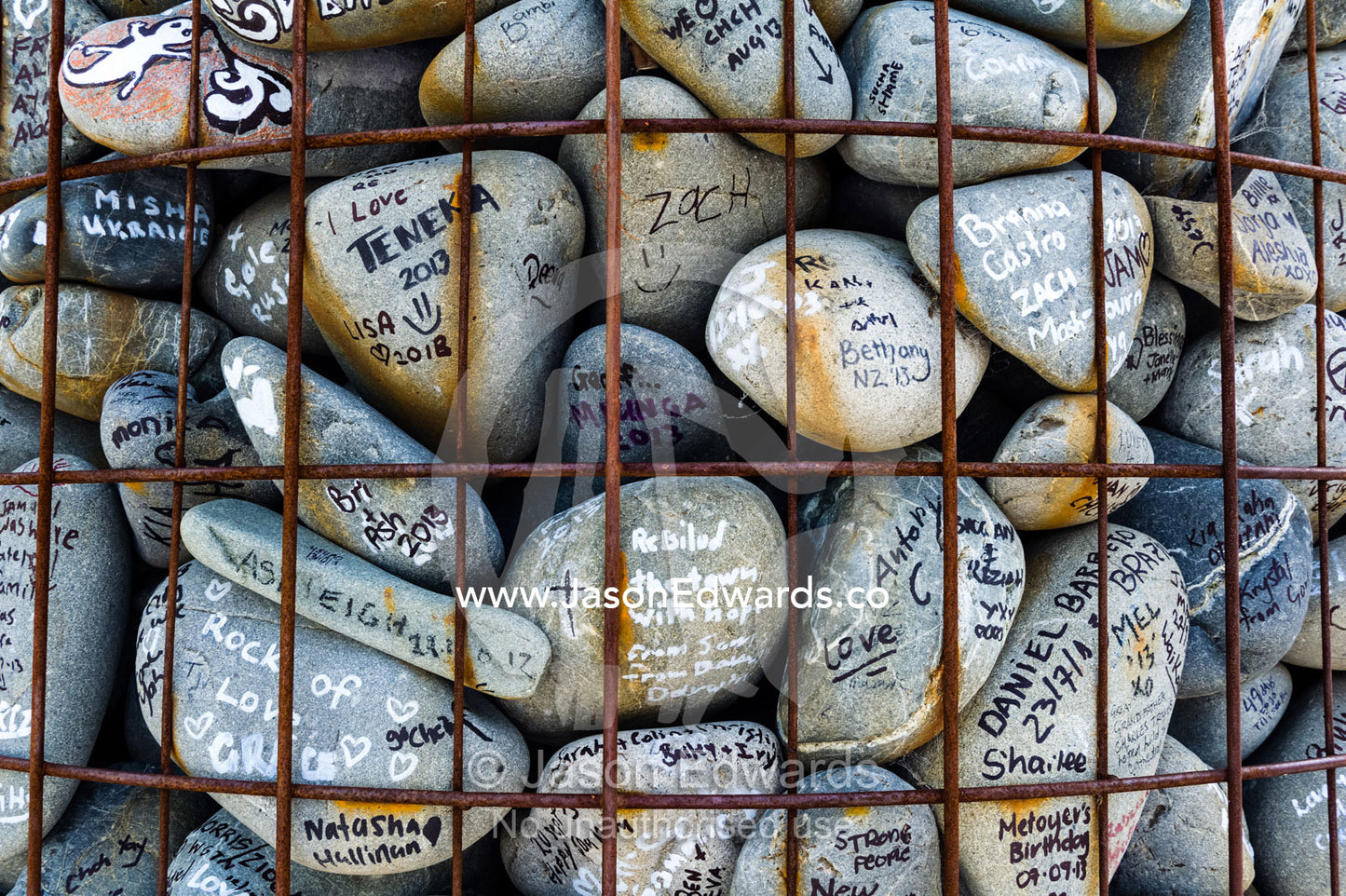 People write messages of love and support on stones for residents of a city after an earthquake. Christchurch, South Island, New Zealand.