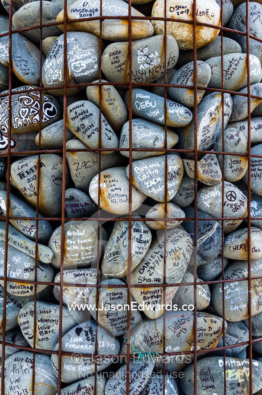 People write messages of love and support on stones for residents of a city after an earthquake. Christchurch, South Island, New Zealand.