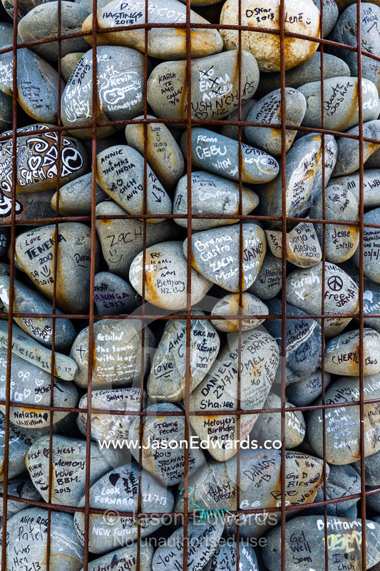 People write messages of love and support on stones for residents of a city after an earthquake. Christchurch, South Island, New Zealand.
