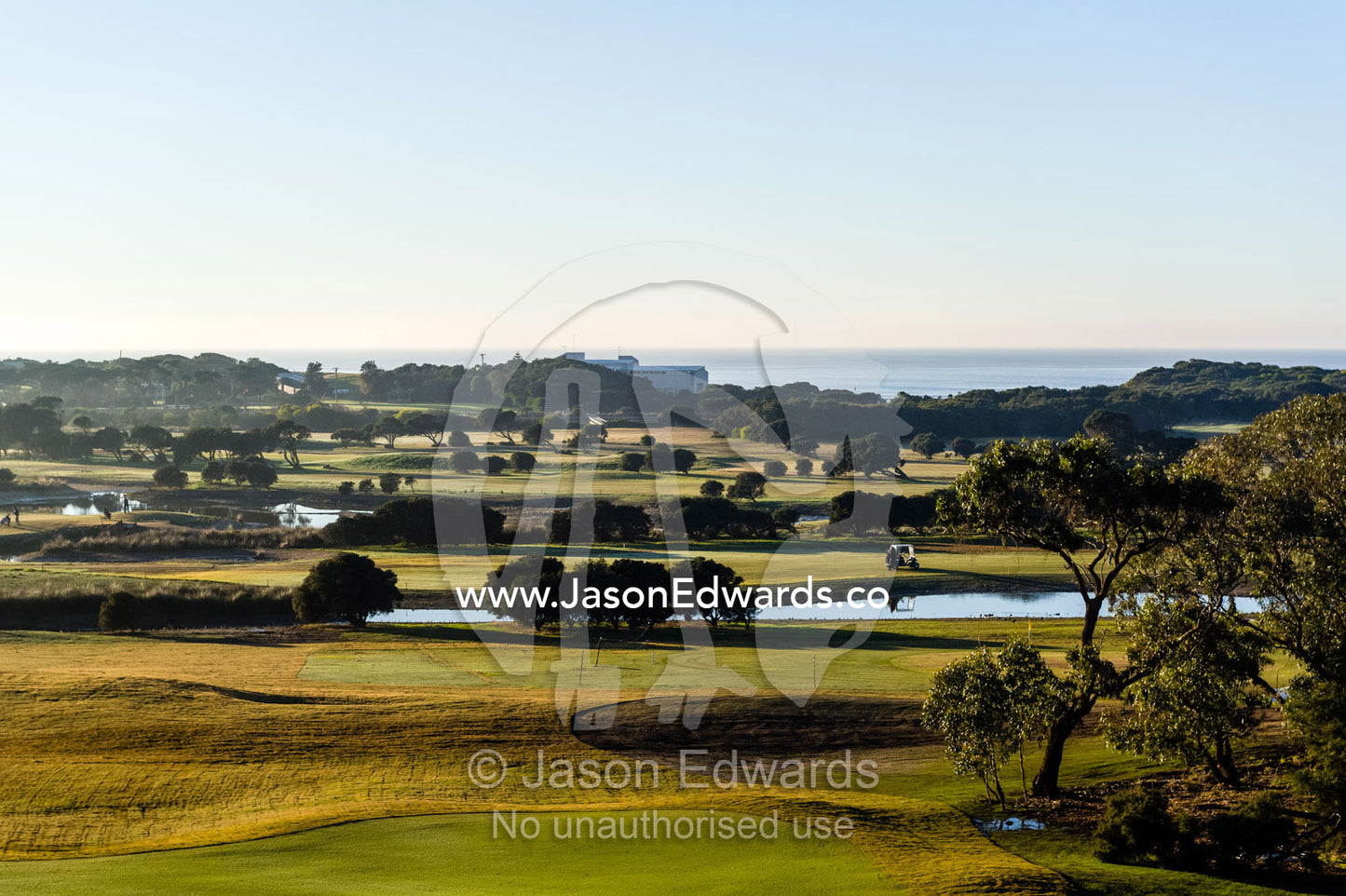 A bright sunny morning over the fairways and putting greens of a golf course by the ocean. RACV Torquay Resort, Torquay, Great Ocean Road, Surf Coast, Victoria, Australia.