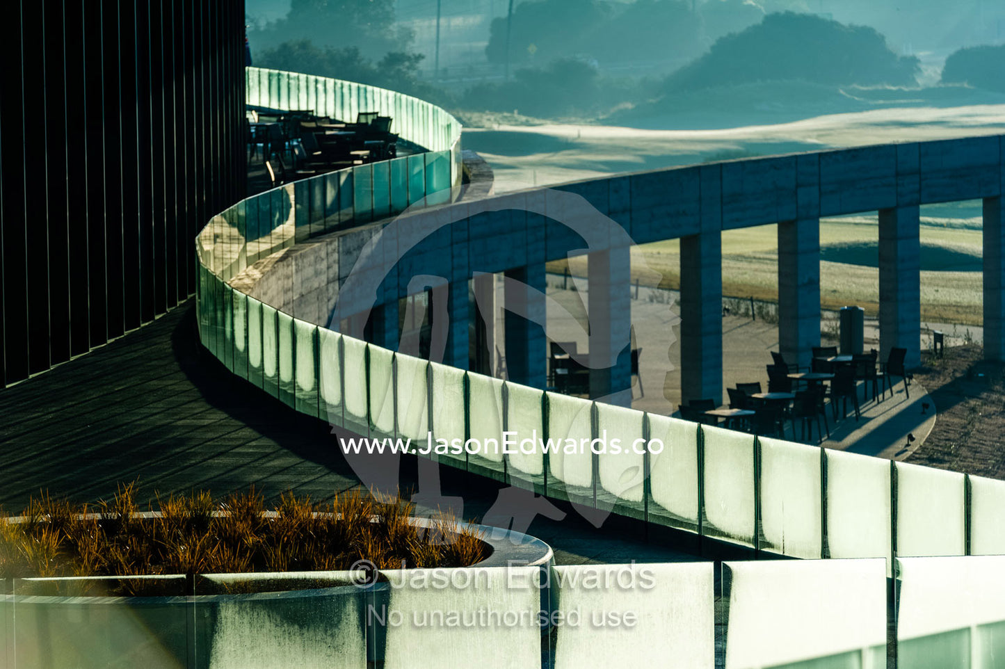 Dawn dew on the panels of a glass balcony overlooking a golf course. RACV Torquay Resort, Torquay, Great Ocean Road, Surf Coast, Victoria, Australia.