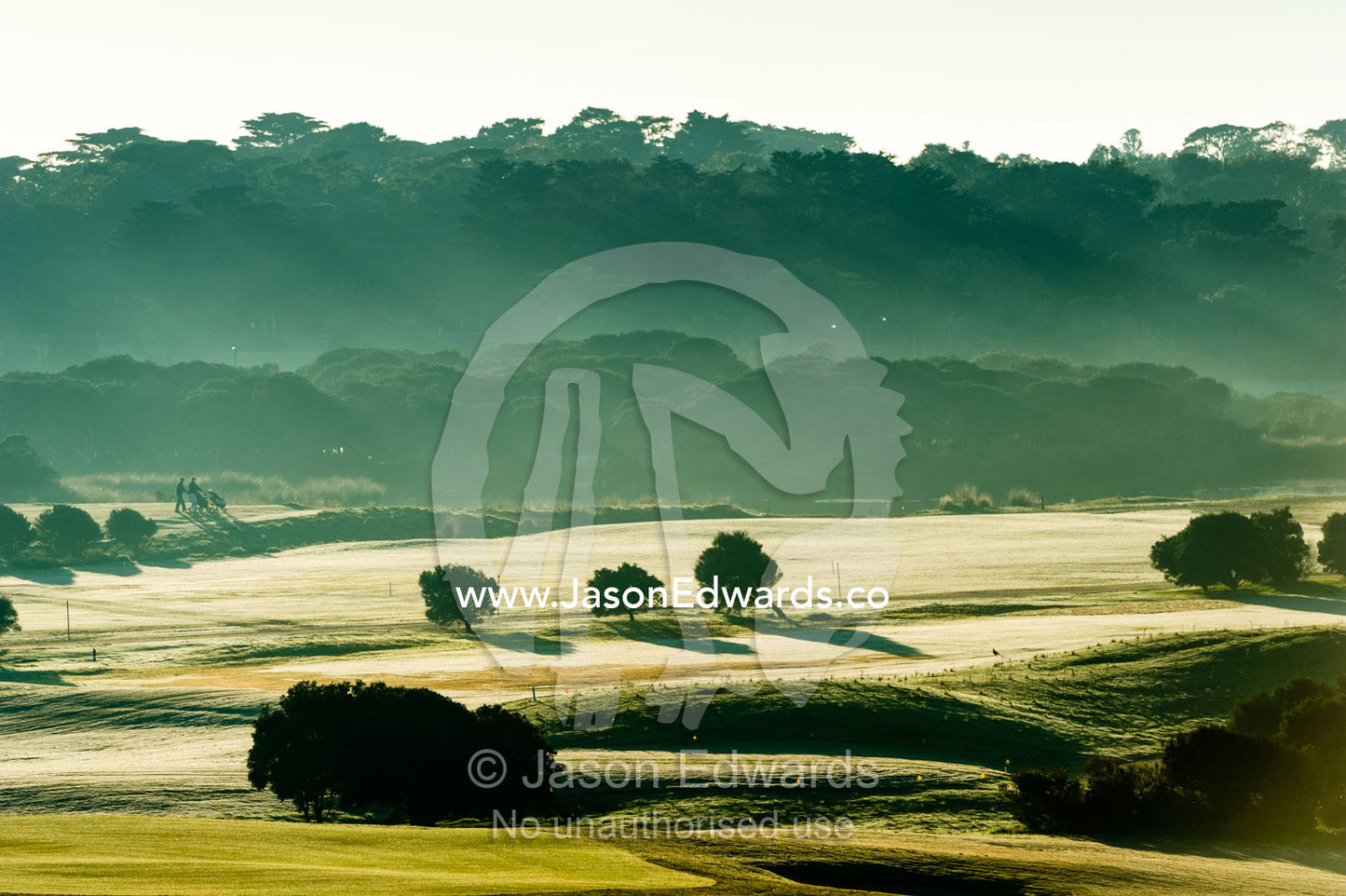 A bright sunny morning mist over the fairways and putting greens of a golf course by the ocean. RACV Torquay Resort, Torquay, Great Ocean Road, Surf Coast, Victoria, Australia.