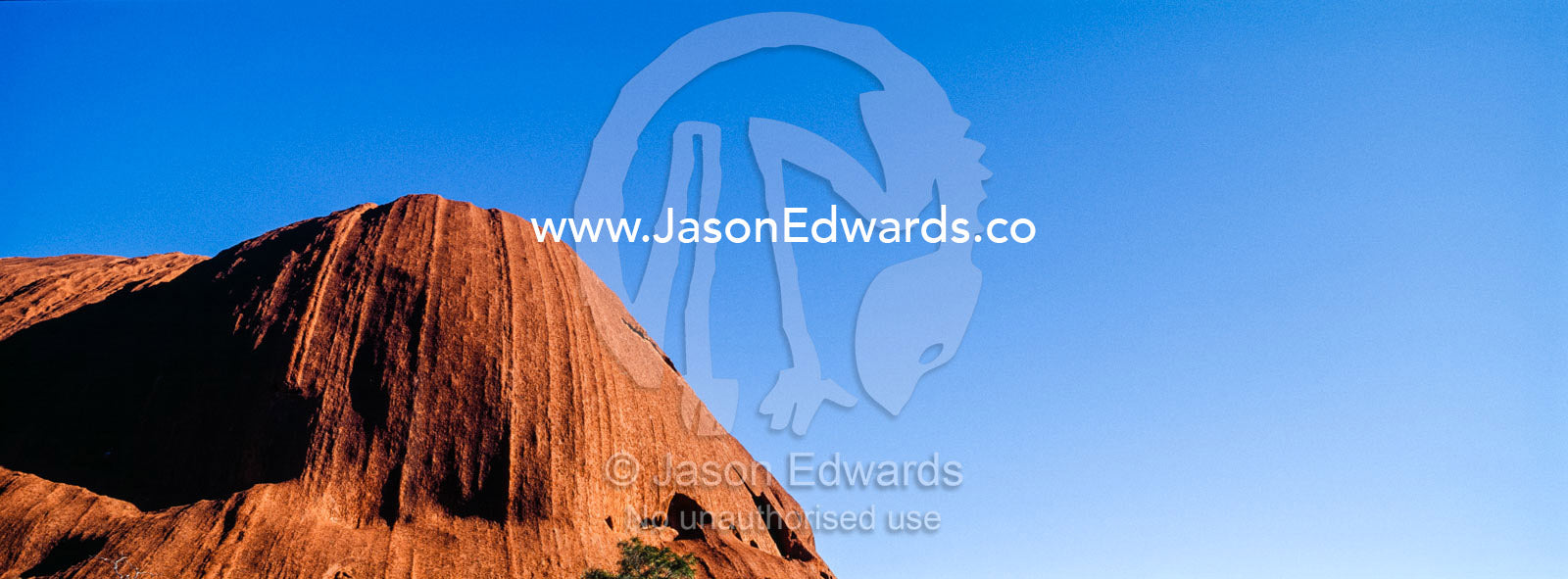 A sandstone dome on Uluru points into a clear blue desert sky. Uluru Kata Tjuta National Park, Northern Territory, Australia.