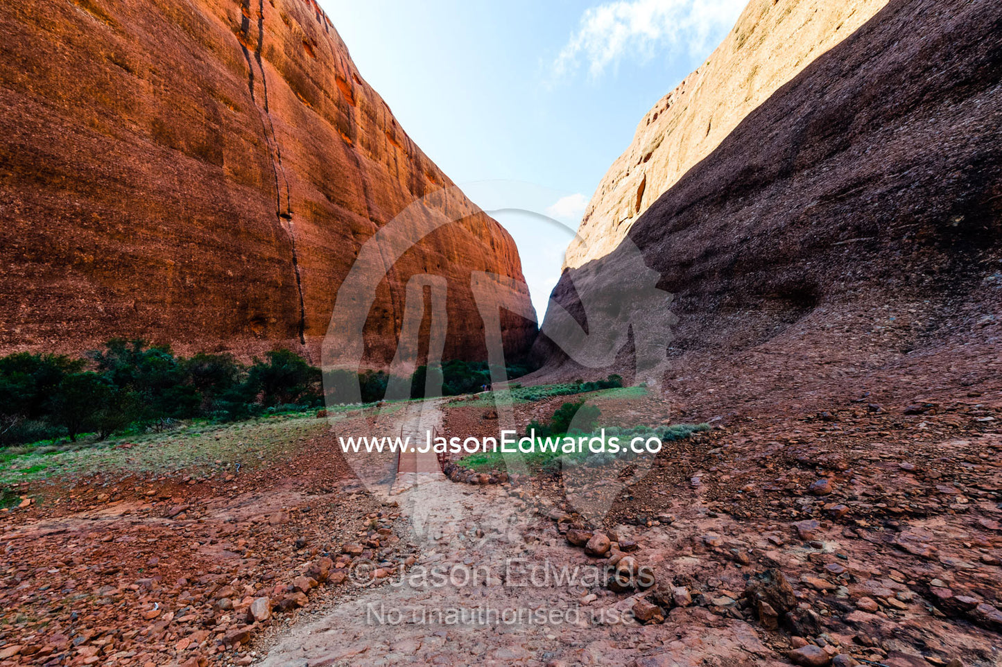 A hiking trail leads between the sandstone domes of Kata Tjuta in the Australian outback. Uluru Kata Tjuta National Park, Northern Territory, Australia.