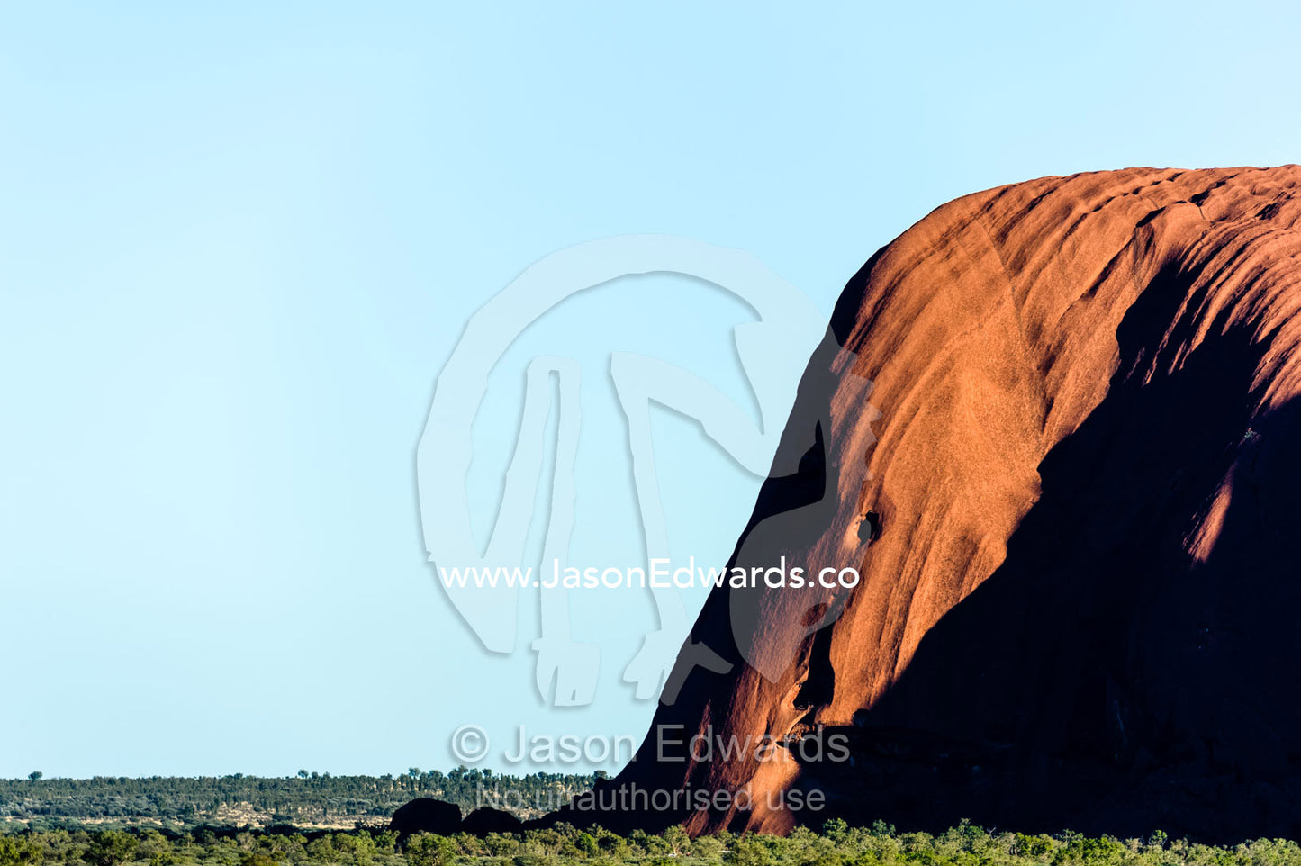 A sandstone buttress of Uluru anchors the rock to the desert plain. Uluru Kata Tjuta National Park, Northern Territory, Australia.