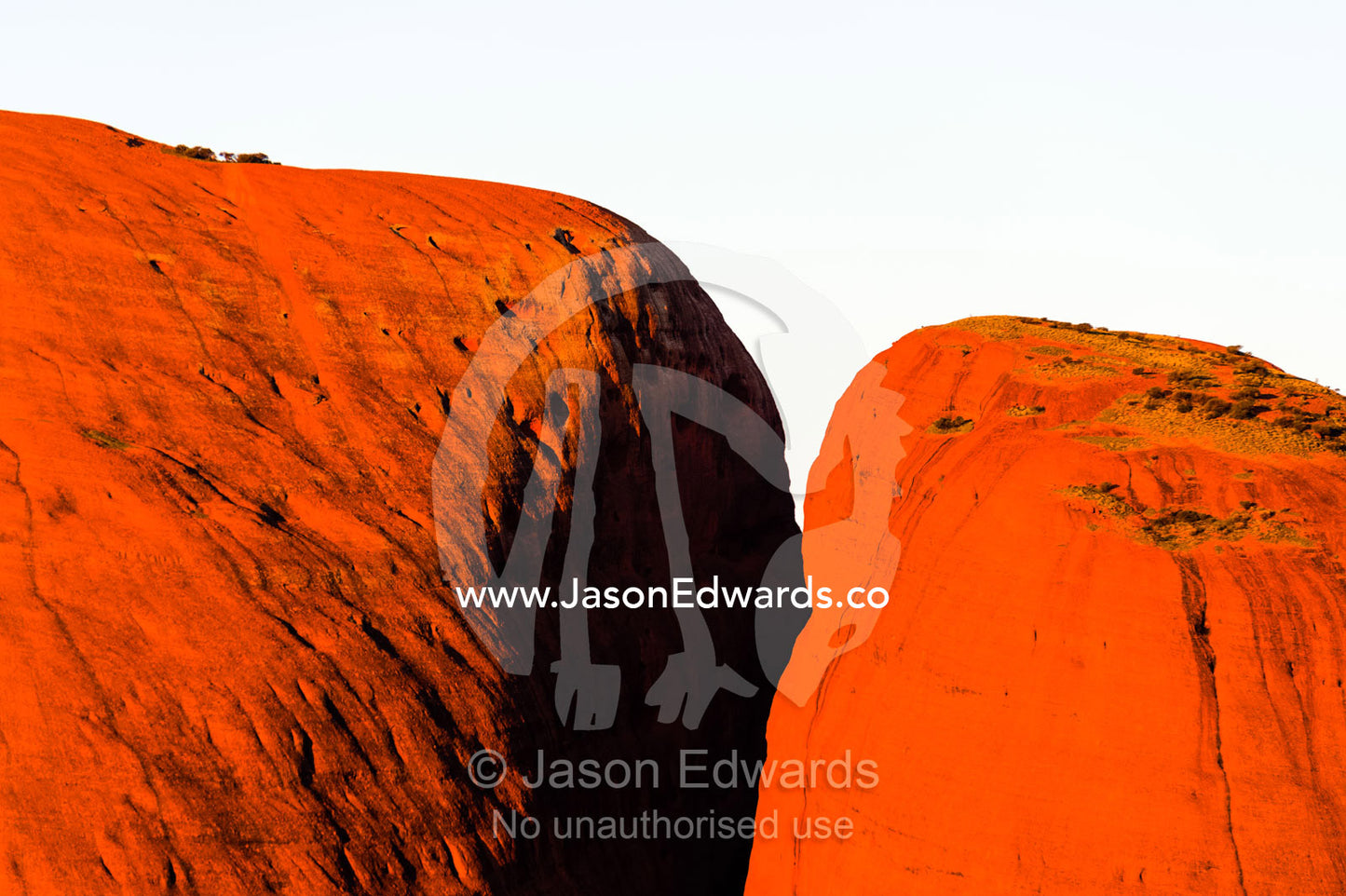 The summit of a baking ochre stone dome of Kata Tjuta at sunset. Uluru Kata Tjuta National Park, Northern Territory, Australia.